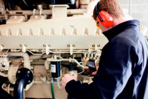 man testing equipment in machine room