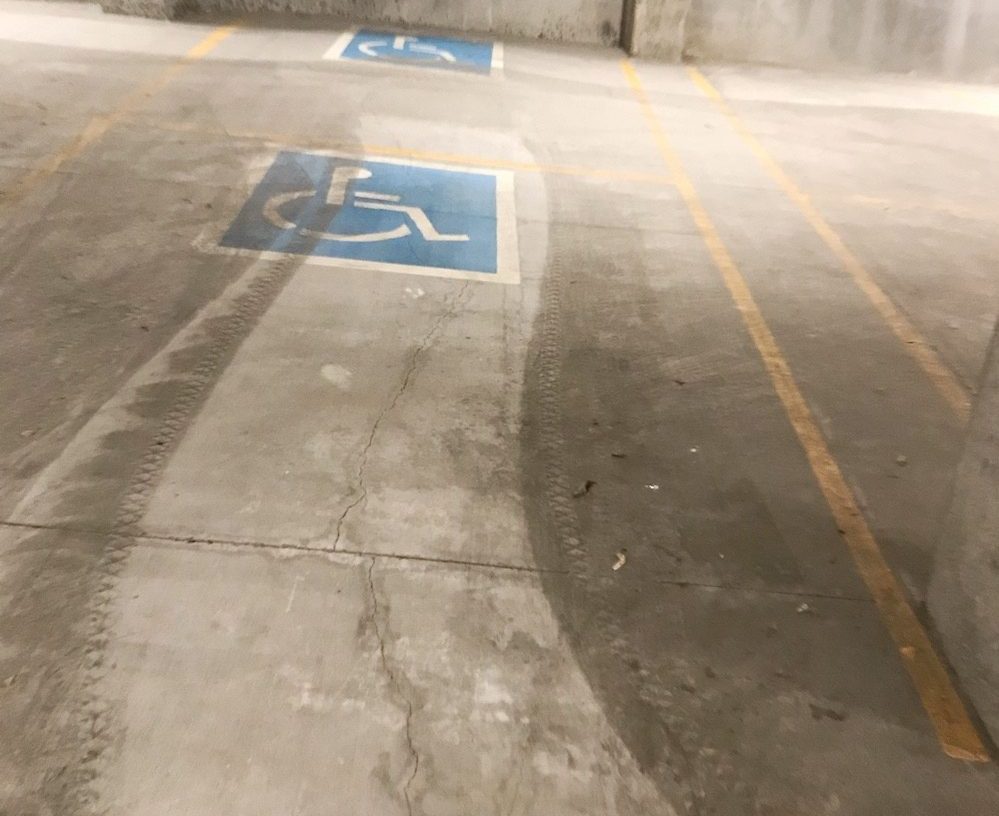 handicap parking space with clean streak after sweeping